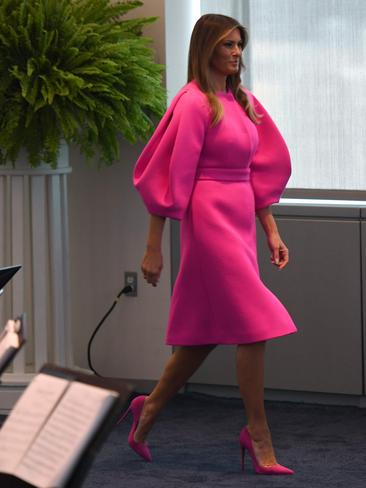 SEPTEMBER 20: The First Lady ensured she was the centre of attention as she prepared to address the spouses of world leaders at a United Nations luncheon in New York. Her hot pink Delpozo outfit featured dramatic sleeves and was paired with equally colourful heels. Picture: AFP