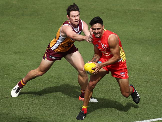 Izak Rankine of the Suns is tackled by Lachie Neale of the Lions compete for the ball during the AFL pre-season practice match between the Gold Coast Suns and the Brisbane Lions at Metricon Stadium on February 23, 2019 in Gold Coast, Australia. (Photo by Chris Hyde/Getty Images)