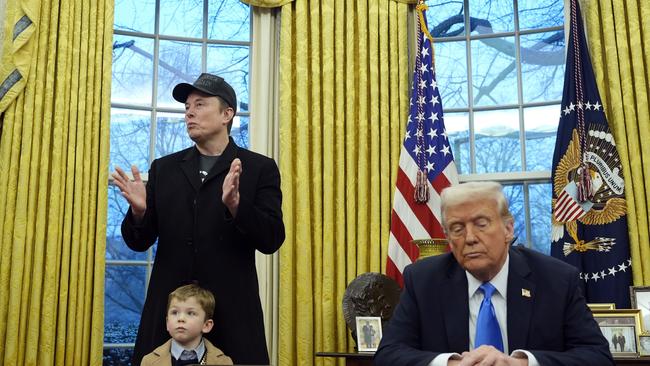 Donald Trump listens as Elon Musk, with his son X, speaks in the Oval Office at the White House in February. Picture: AP