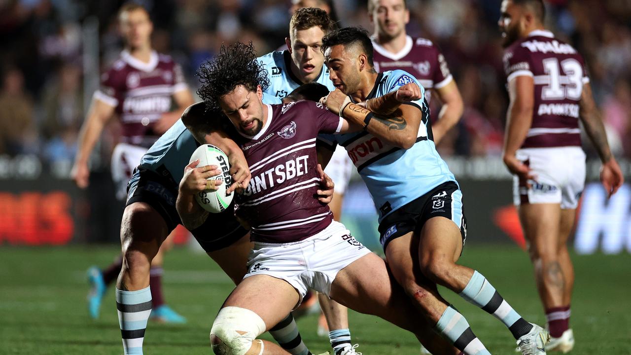 Josh Aloiai is wrapped up the Sharks’ defence. Picture: Cameron Spencer/Getty Images
