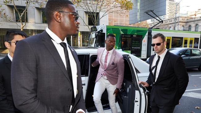 Nelly Yoa arrives at the Melbourne Magistrates Court last week in Rolls Royce with a security detail. Picture: AAP