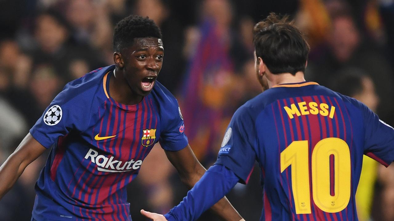 Ousmane Dembele of Barcelona celebrates with Lionel Messi.