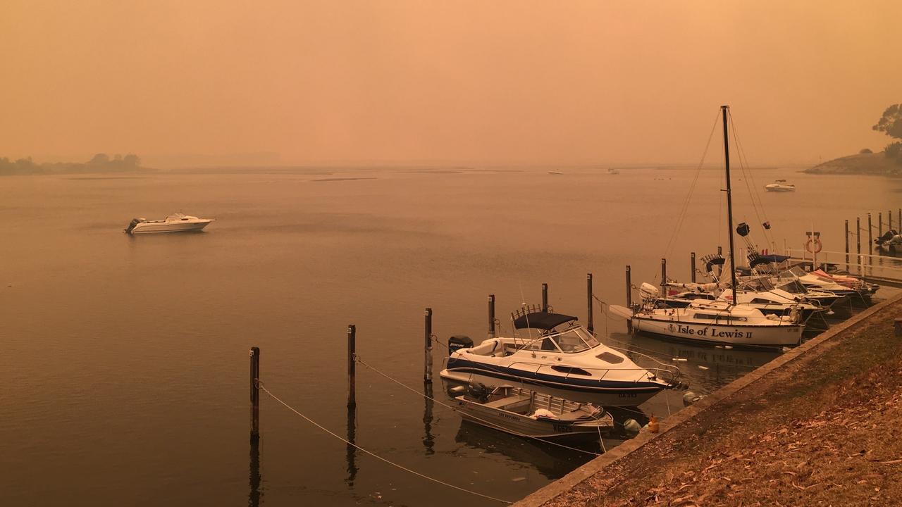 The fires turned Mallacoota’s skies red and the mountains black. Fire roared down the only road into and out of Mallacoota, and it took a naval evacuation to reconnect the town to a shocked nation. Picture: Cassandra Smith.