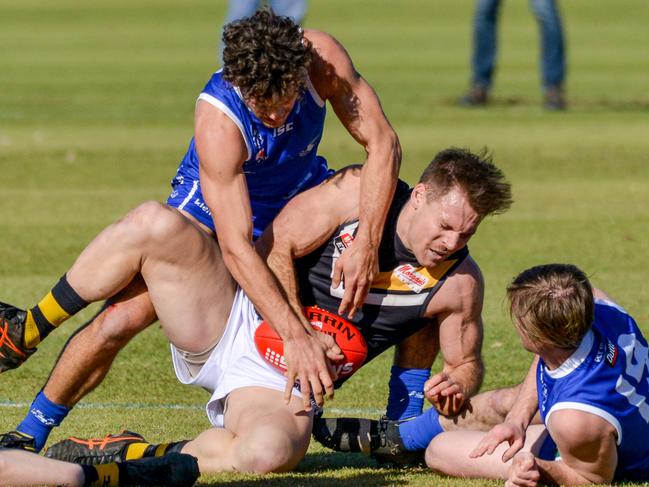 Adelaide Footy League division one match between St Peter's Old Collegians and Brighton Bombers at Caterer Oval (St Peter's College), August 1, 2020. Brightons Nigel Osborn is tackled by St Peters (28 no name) and Patrick Fahey (right). Picture: Brenton Edwards