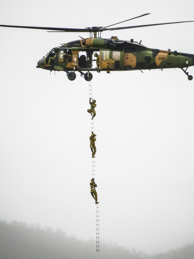 Australian Army soldiers from 2nd Commando Regiment practice climbing a wire ladder underneath a 6th Aviation Regiment Black Hawk helicopter during a training activity as part of Exercise Talisman Sabre 2019 in Townsville. Picture: Defence Media