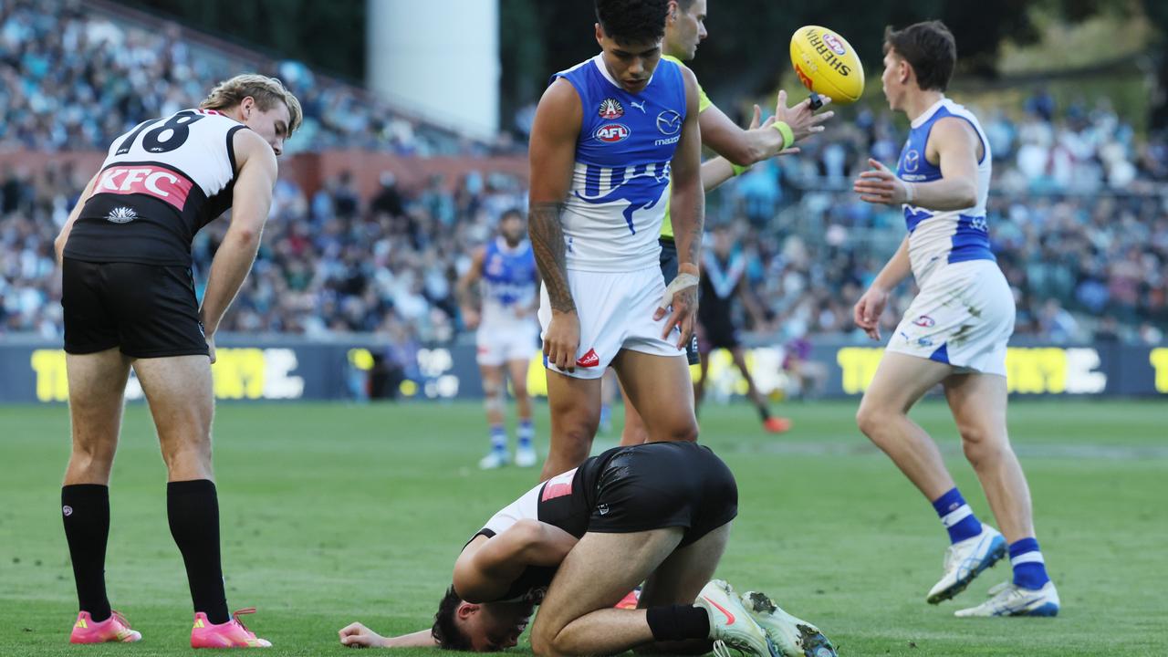 Curtis tackled Sinn from behind, the momentum carrying them both forward. Photo by James Elsby/AFL Photos.