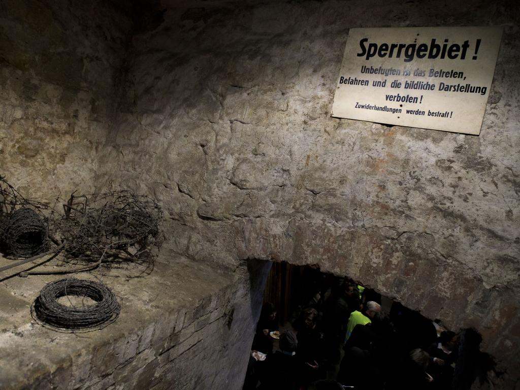 A sign saying ‘restricted area’ is fixed over the entrance to a restored tunnel once used in an attempt to help people escape from East Berlin into West Berlin. Picture: Carsten Koall/Getty Images.