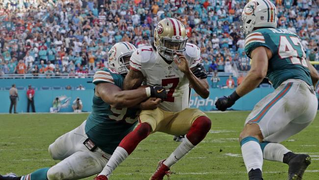 San Francisco 49ers quarterback Colin Kaepernick (7) is tackled by Miami Dolphins defensive tackle Ndamukong Suh in the final play of the game.