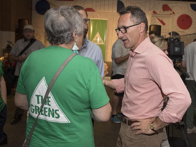 Tough times. Greens Leader Dr Richard Di Natale (right) speaks to supporters at the Greens election night party. Picture: AAP Image/Ellen Smith