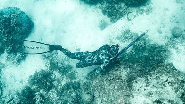 Glenn Dickson back in the water spear fishing after he lost his leg in a shark attack.