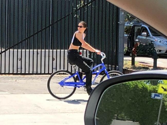 Jenner rocked a white crop top with a small handbag swung over her shoulder. Picture: MEGA