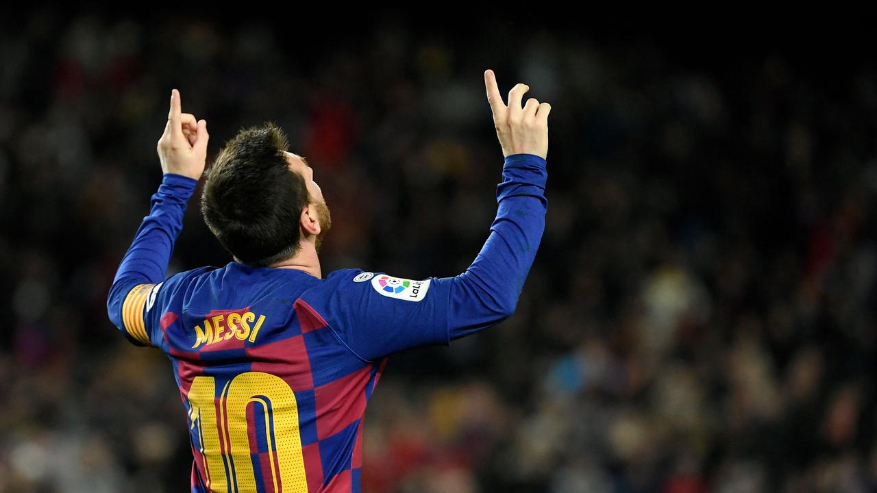 Argentinian football player Lionel Messi holds-up his number 30 shirt while  standing on the pitch during a press conference at the French football club Paris  Saint-Germain's (PSG) Parc des Princes stadium in