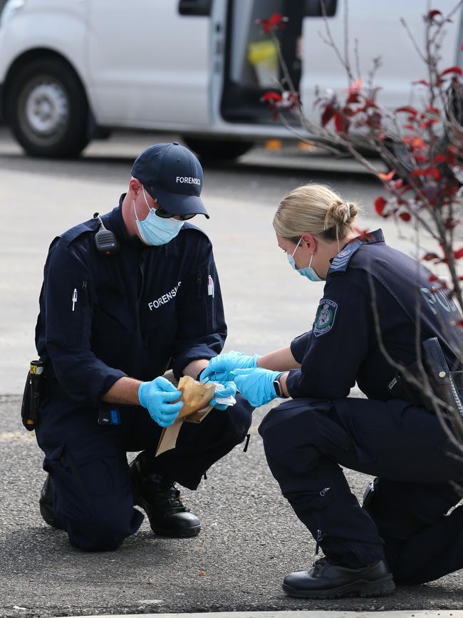 Forensics officers collect evidence from Monday’s scene. Picture: Gaye Gerard