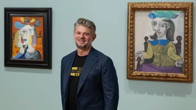 National Gallery of Australia director Nick Mitzevich, in front of two Picasso paintings.