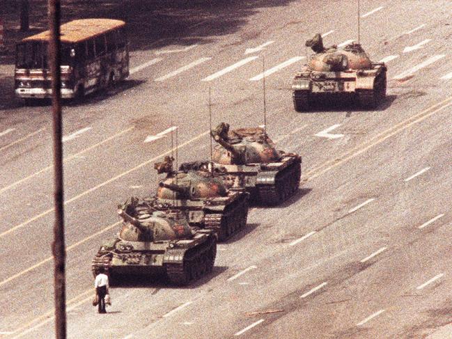 TAUS 60th Anniversary. A man stands in front of a convoy of tanks in the Avenue of Eternal Peace in Beijing, June 5, 1989. REUTERS/Arthur Tsang