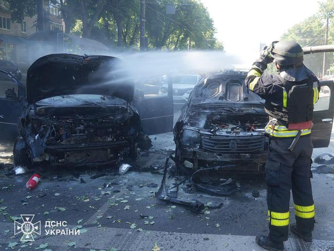 A Ukrainian rescuer extinguishes a burning car following a missile attack in Sumy. Picture: Handout / UKRAINIAN EMERGENCY SERVICE / AFP