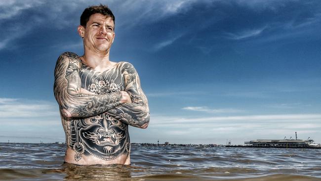 Pain in the backside worth it in the long run for jockey Nick Hall, who is pictured soothing his aches and pains with a recent dip in Port Phillip Bay. Picture: Colleen Petch