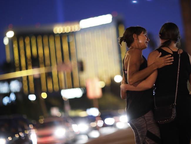 Madisen Silva, right, and Samantha Werner at a makeshift memorial for victims of the mass shooting. Picture: John Locher/AP