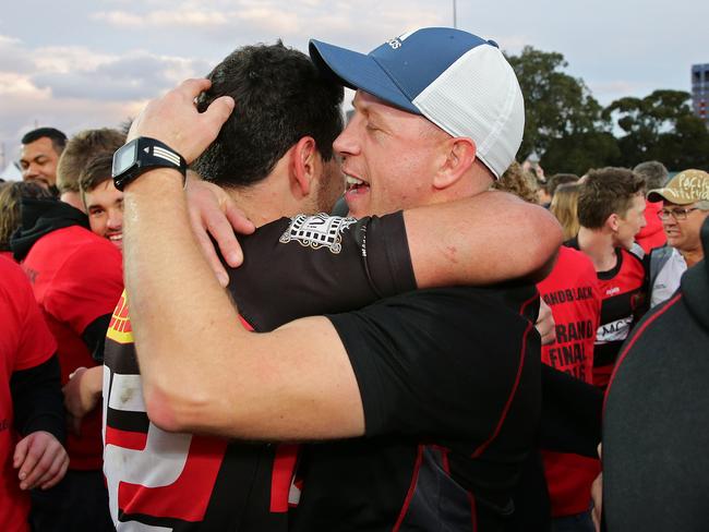 Coach Simon Cron hugs try-scorer Richie Woolf.