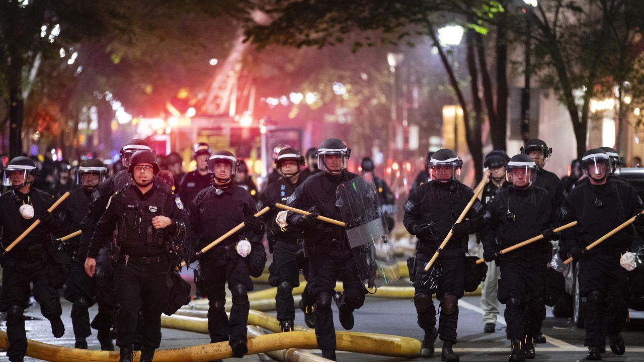 Police push down a street in Philadelphia on Saturday. Picture: Matt Rourke/AP