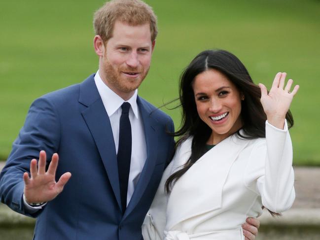 (FILES) In this file photo taken on November 27, 2017 Britain's Prince Harry and his fiancée US actress Meghan Markle pose for a photograph in the Sunken Garden at Kensington Palace in west London, following the announcement of their engagement. - Britain's Prince Harry and his wife Meghan will step back as senior members of the royal family and spend more time in North America, the couple said in a historic statement Wednesday. (Photo by Daniel LEAL-OLIVAS / AFP)