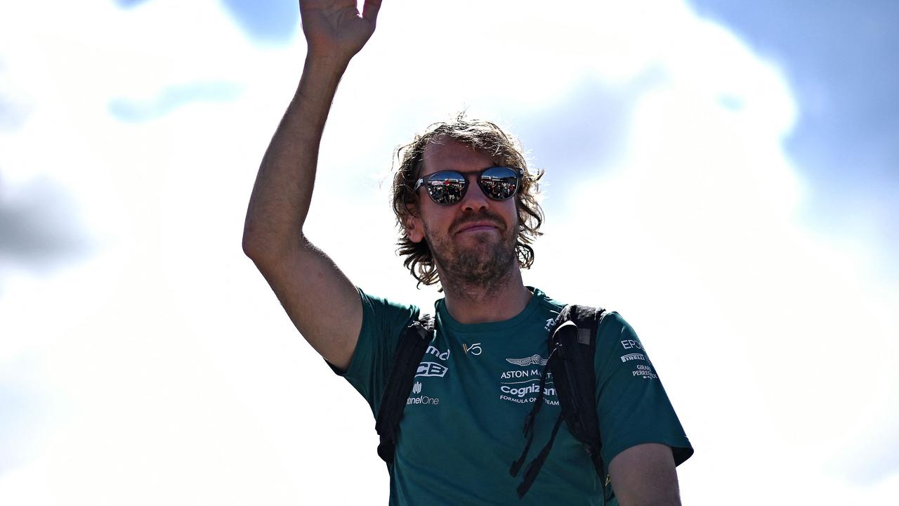 (FILES) In this file photo taken on July 03, 2022 Aston Martin's German driver Sebastian Vettel waves to fans as he arrives ahead of the Formula One British Grand Prix at the Silverstone motor racing circuit in Silverstone, central England. - Four-time F1 champion Sebastian Vettel is to retire at end of the season, his team said on July 28, 2022. (Photo by Ben Stansall / AFP)