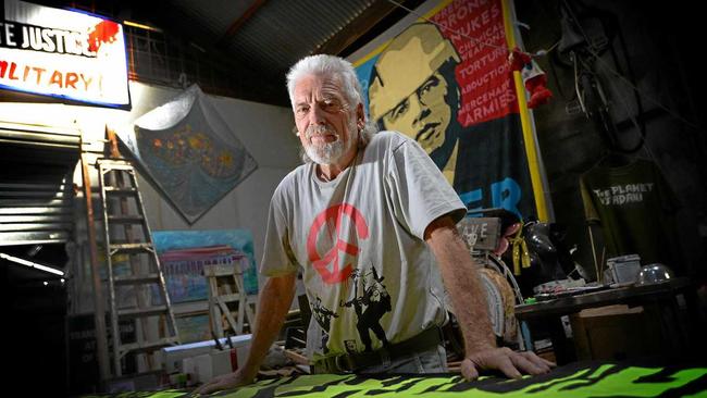 Peace activist Graeme Dunstan works on a banner. Picture: Chris Ison ROK300317cdunstan2