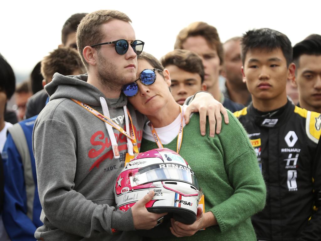 The mother and brother of Anthoine Hubert hold the helmet of Anthoine Hubert during a moment of silence at the Belgian Formula One Grand Prix. Picture: AP