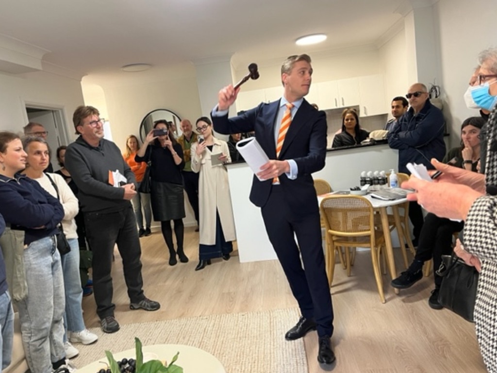 Cooley auctioneer Jake Moore drops the hammer at the auction of an apartment in Carrington Rd Coogee. Picture: Fiona Killman