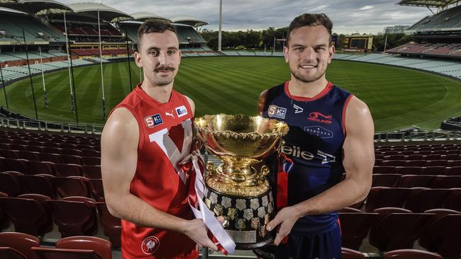 North Adelaide captain Alex Spina and Norwood skipper Matthew Nunn with the premiership cup ahead of Sunday’s epic SANFL grand final. Picture Roy VanDerVegt