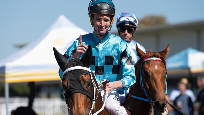 Jockey Ryan Plumb gestures after riding Sugar Sizzle to victory during the Viva Racing Race Day at Gold Coast Turf Club in 2018. Picture: AAP Image/Albert Perez