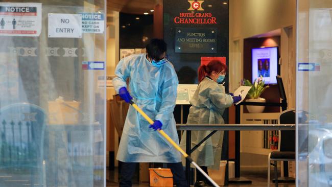 Staff wearing PPE clean up at the Hotel Grand Chancellor on Melbourne’s Lonsdale Street which is serving as one of the hotel quarantines. Aaron Francis/The Australian