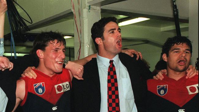 Melbourne's Russell Robertson, Garry Lyon and Jeff Farmer sing the club song after a 1998 Semi-Final win.