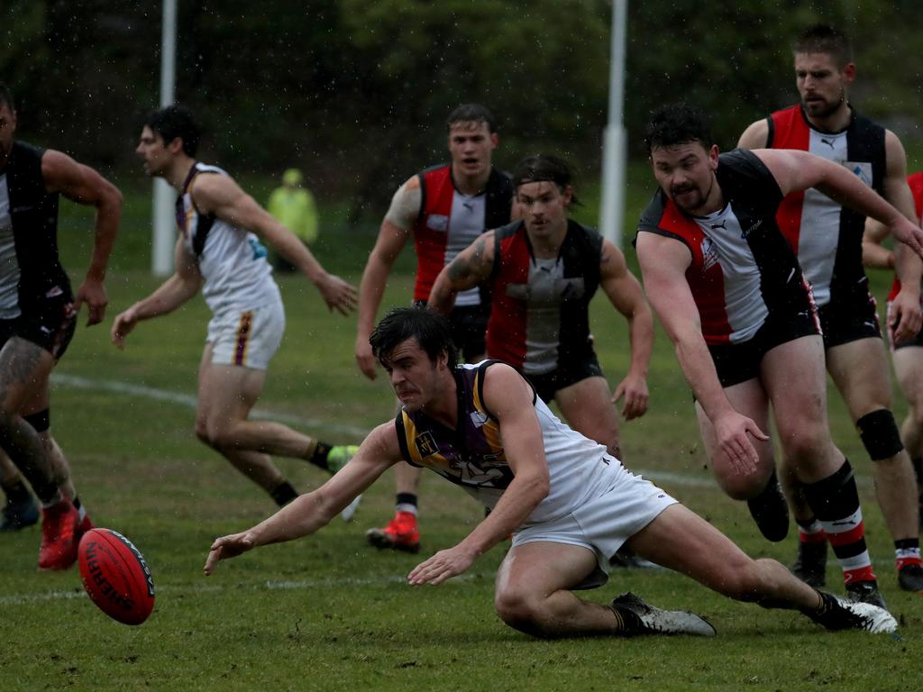 Norwood’s Darcy Fritsch dives to the turf to win possession.