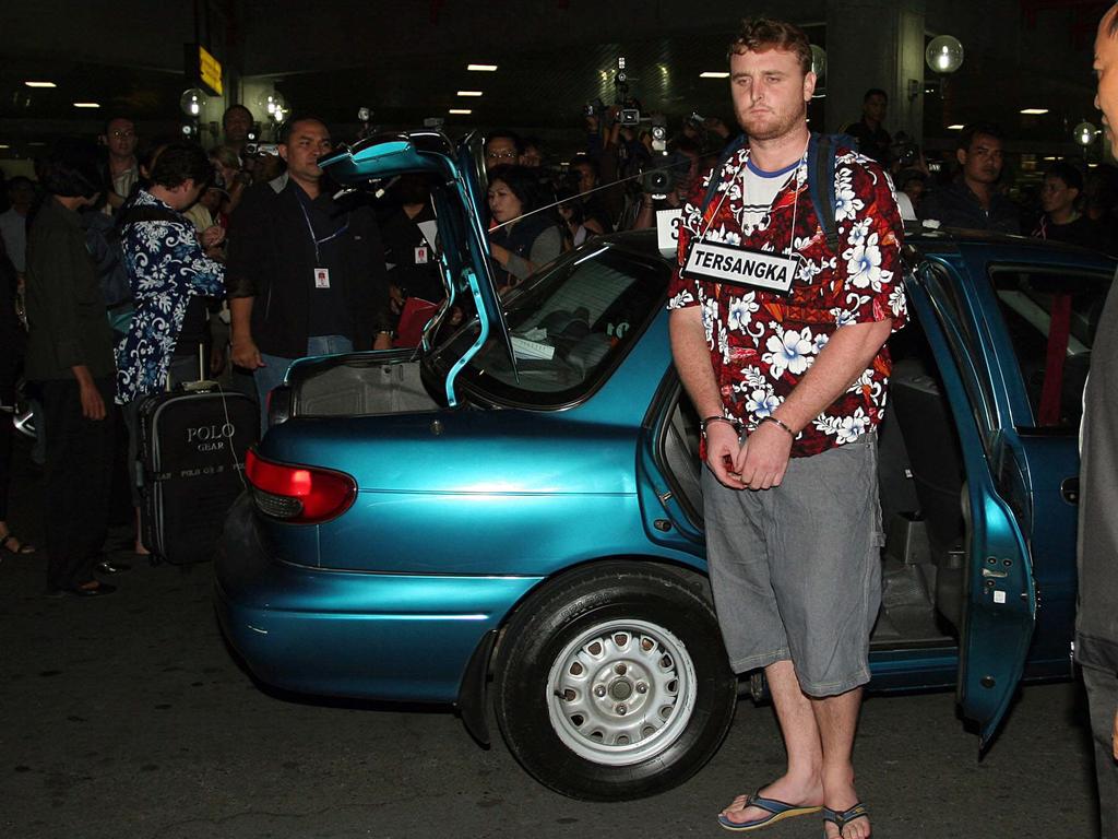 Martin Stephen handcuffed and Renae Lawrence arrive at Ngurah Rai airport for the re-enactment of their heroin arrest. Picture: Lukman S Bintoro.