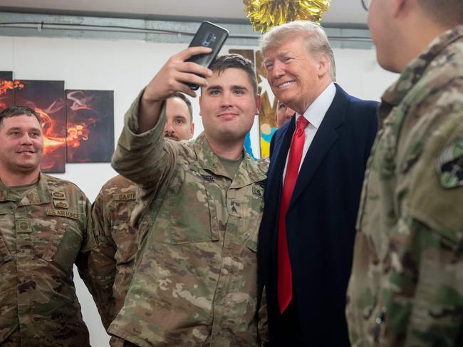 US President Donald Trump with soldiers at the air base. He visited in 2018. Picture: AFP