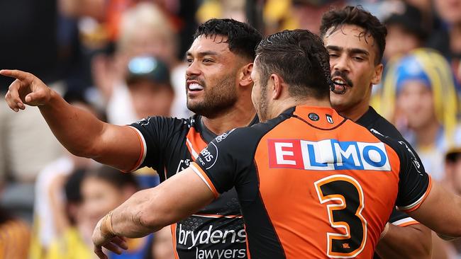 SYDNEY, AUSTRALIA - APRIL 18: David Nofoaluma of the Wests Tigers celebrates scoring a try with team mates during the round six NRL match between the Parramatta Eels and the Wests Tigers at CommBank Stadium on April 18, 2022, in Sydney, Australia. (Photo by Cameron Spencer/Getty Images)