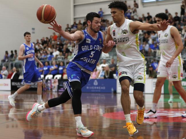 Jason Cadee (left) of Gold Coast Rollers and Jaylin Galloway of Ipswich Force in action during Game 3 decider of the NBL1 North Grand Final Series played at the Carrara Indoor stadium, Gold Coast, Sunday, August 6, 2023. Photo: Regi Varghese