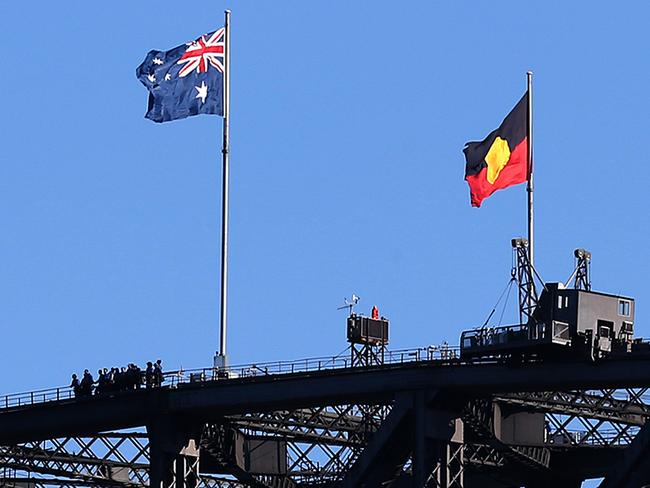 The Australian national and Aboriginal flags fly atop Sydney; s Harbour Bridge. Picture: AAP Image