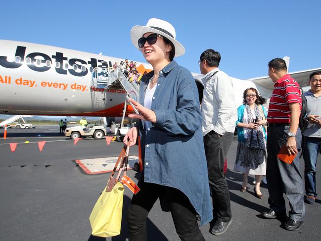 The first direct flights from Wuhan China to the Gold Coast touched down this morning. Photo of Amy Jiang on the tarmac. Pic by Richard Gosling