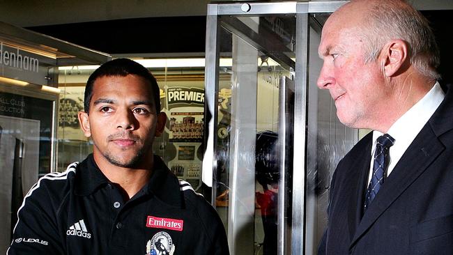 Leon Davis and Rex Hunt shake hands in the foyer of the Lexus centre.