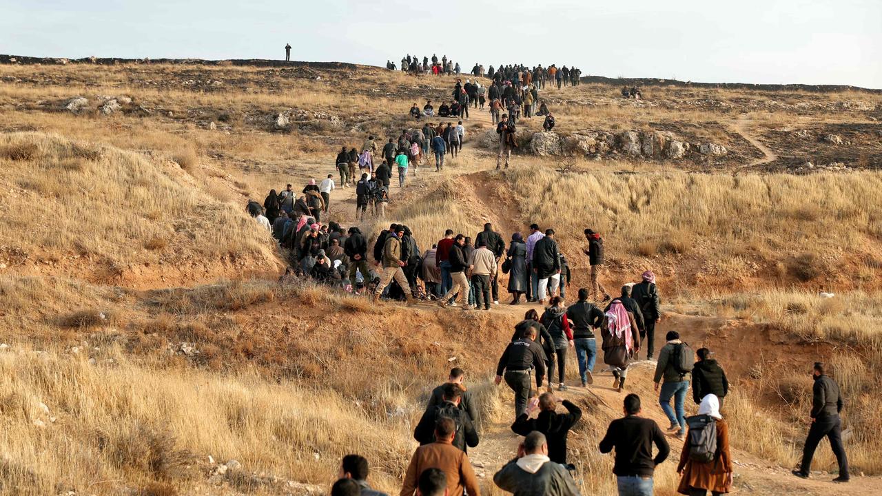 People make their way towards the Sednaya prison in Damascus looking for loved ones. Picture: Omar Haj Kadour/AFP