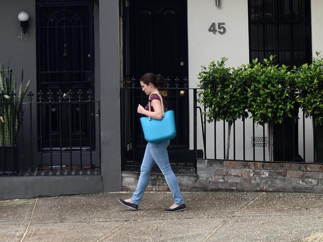 A women walks past some residential houses in Sydney on Wednesday, Oct. 14, 2015. Westpac will raise its variable mortgage rates by 0.20 percentage points to 5.68 per cent on November 20, when residential investment property loan rates will go up by the same amount to 5.95 per cent. (AAP Image/Paul Miller) NO ARCHIVING