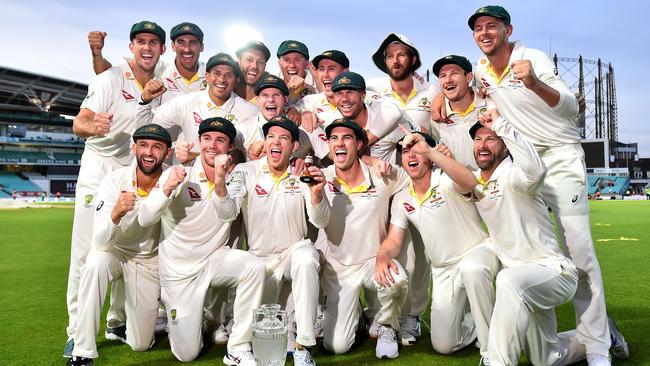 Australia's captain Tim Paine holds the Ashes Urn as the players celebrate victory after the presentation ceremony on the fourth day of the fifth Ashes cricket Test match at The Oval.