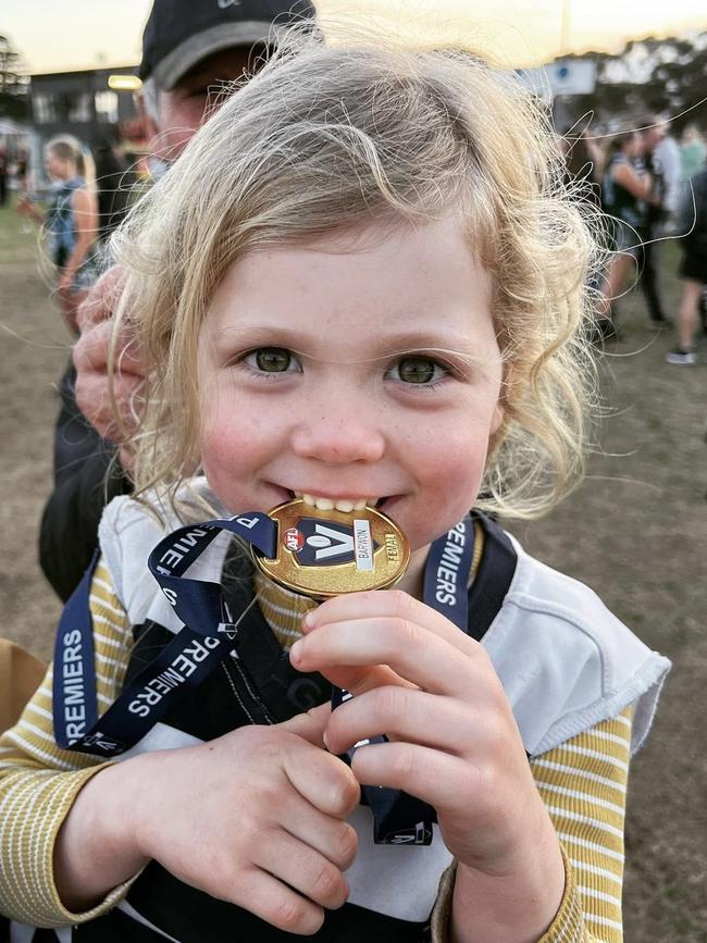 Patrick and Mardi Dangerfield's daughter Felicity with her premiership medal