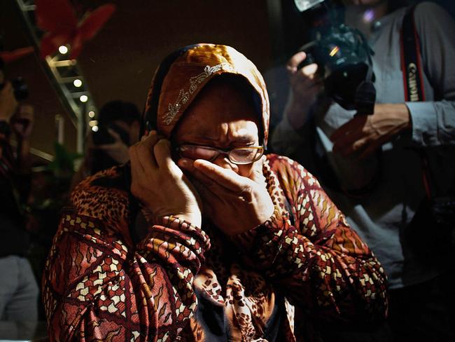 A family member cries as she receives the news of the ill fated flight MH17 on the phone. Picture: Rahman Roslan