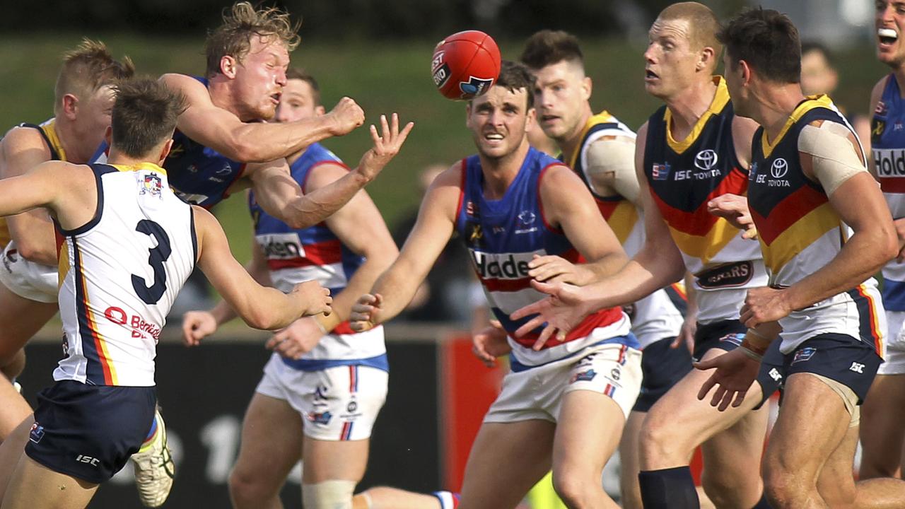 SANFL: Central District v Adelaide at Elizabeth Oval. Central's Travis Schiller gets a handball under pressure.15 June 2019. (AAP Image/Dean Martin)