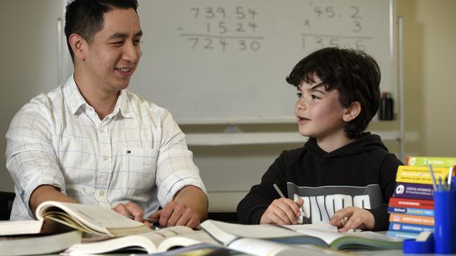 Ryan Ou, owner and tutor at Bayside Academics in Brighton, with student Jackson Bartlett, 8. Picture: Andrew Henshaw