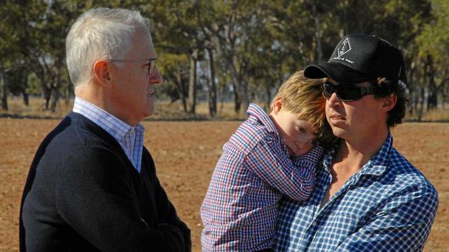 TOUGH TIMES: Prime Minister Malcolm Turnbull speaks with farmer Phillip Miles and his son Jack during his June visit to Strathmore Farm in Trangie NSW, as part of a tour of regional NSW and Queensland  communities struggling with drought. Picture: IVAN MCDONNELL