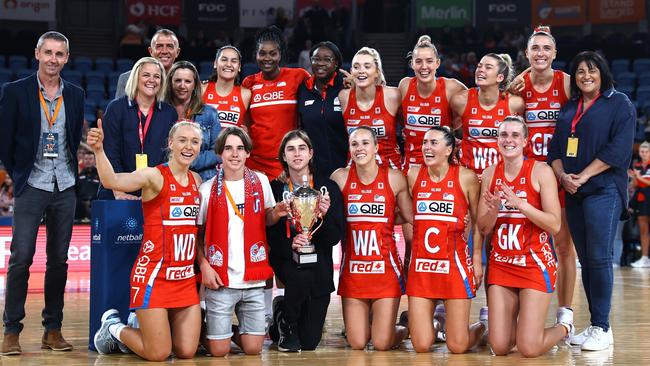 The NSW Swifts with the Carole Sykes Trophy after their win over the Giants on Saturday night. Photo: Getty Images